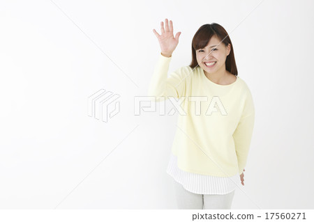 A woman waving a hand 17560271