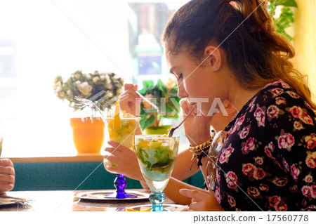 Young girl eats ice cream Young girl eats ice cream 17560778