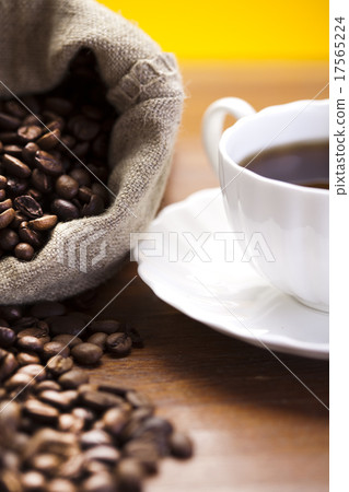 Coffee over dark roasted coffee beans 17565224