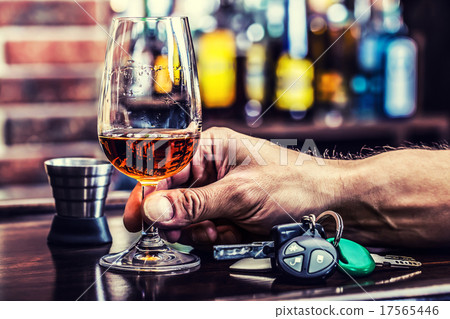 Alcoholism. Cup cognac or brandy hand man the keys 17565446