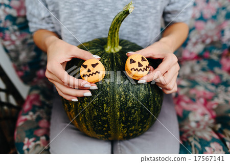 woman holding a biscuit for Halloween 17567141