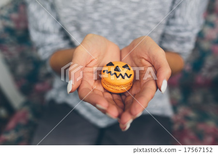 woman sitting and holding a cookie woman sitting and holding a cookie 17567152