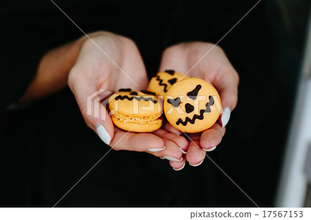 woman holding a biscuit for Halloween 17567153