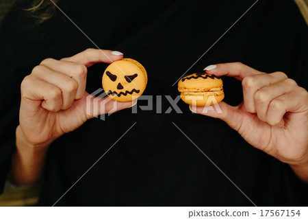 woman holding a biscuit for Halloween woman holding a biscuit for Halloween 17567154