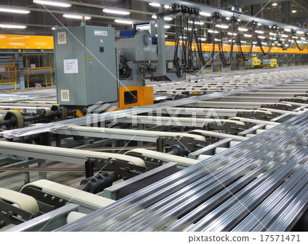 Aluminum lines on a conveyor belt in a factory. Aluminum lines on a conveyor belt in a factory. 17571471