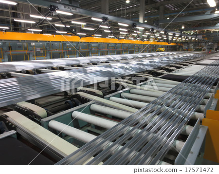 Aluminum lines on a conveyor belt in a factory. Aluminum lines on a conveyor belt in a factory. 17571472