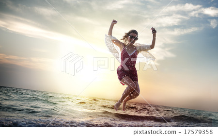 Beach Woman Jumping Summer Holiday Chilling Concept Beach Woman Jumping Summer Holiday Chilling Concept 17579358
