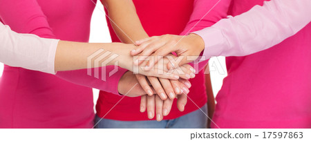 close up of women in pink shirts with hands on top 17597863