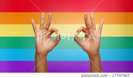 hands showing ok sign over rainbow background hands showing ok sign over rainbow background 17597865