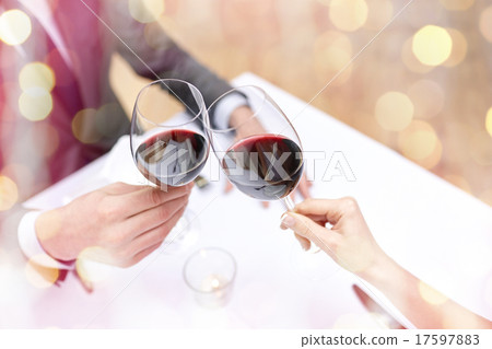 young couple with glasses of wine at restaurant 17597883