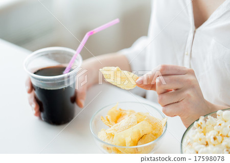 close up of woman with junk food and coca cola cup 17598078