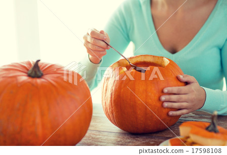 close up of woman with pumpkins at home 17598108