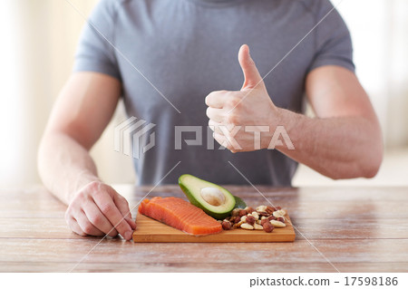 close up of male hands with food rich in protein 17598186