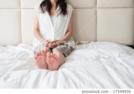 A ladly sitting woman on the bed 17599936