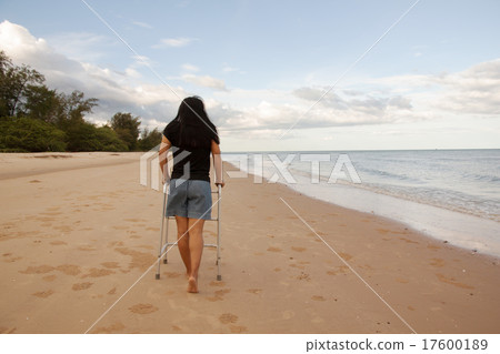 woman use walker on sand beach woman use walker on sand beach 17600189