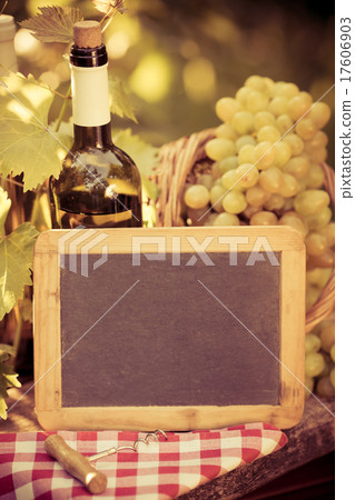 Wooden blackboard blank, wine bottle and grapes 17606903