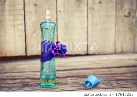 Blue perfume bottle on the wooden background. Tone Blue perfume bottle on the wooden background. Tone 17615222