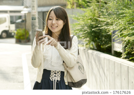 A young lady with a smartphone A young lady with a smartphone 17617626
