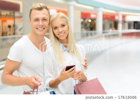 Positive couple holding packages  17618086