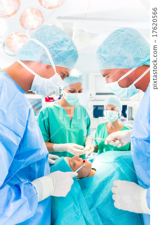 Surgeons operating in operation theater room 17620566