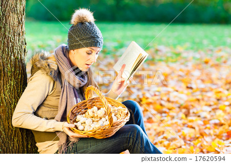 Woman reading book on mushroom foray Woman reading book on mushroom foray 17620594