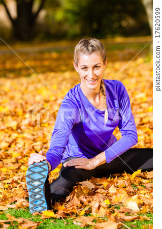 Woman doing gymnastics in autumn foliage Woman doing gymnastics in autumn foliage 17620599