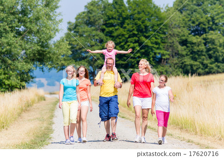 Family having walk on path in summer Family having walk on path in summer 17620716