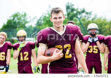 American Football player showing trick with ball American Football player showing trick with ball 17620721
