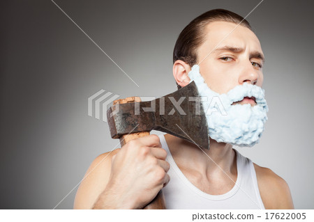Attractive young bearded guy shaves with hatchet 17622005