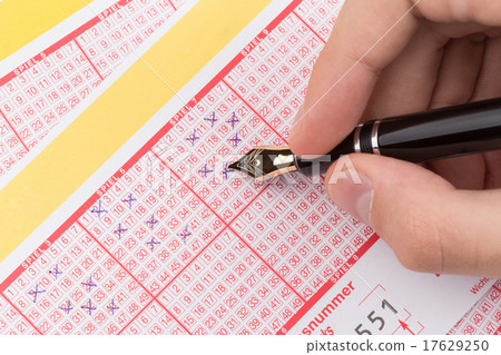 male hand filling lotto ticket 17629250
