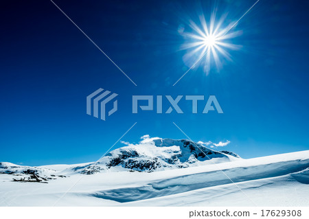 Sun and snowy mountain. 17629308