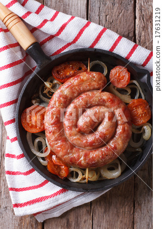 Fried sausage with onions in a pan top view 17631219