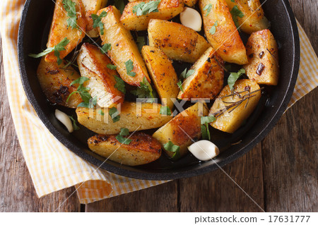 baked potato with garlic in a pan closeup top view baked potato with garlic in a pan closeup top view 17631777