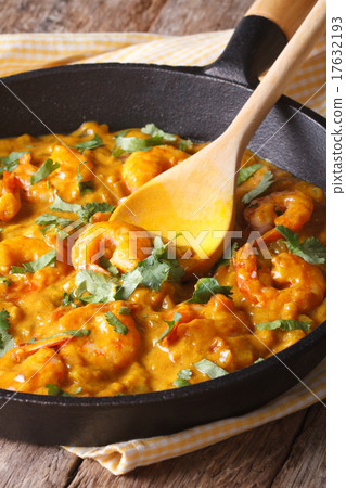 Prawns in curry sauce in a frying pan close-up Prawns in curry sauce in a frying pan close-up 17632193