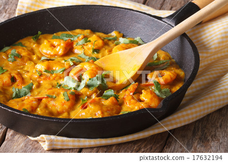 Prawns in curry sauce in a frying pan close-up Prawns in curry sauce in a frying pan close-up 17632194