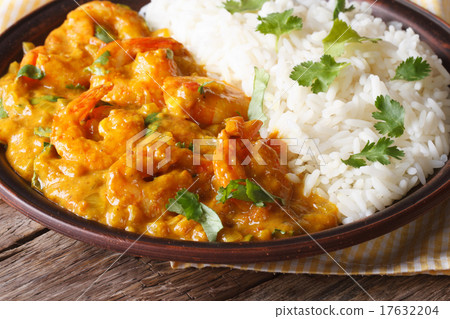 Shrimps in curry sauce with rice and cilantro  17632204