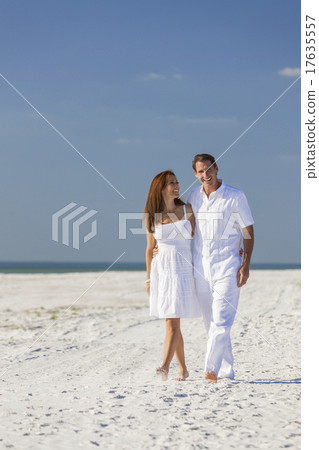 Man Woman Couple Walking on An Empty Beach Man Woman Couple Walking on An Empty Beach 17635557