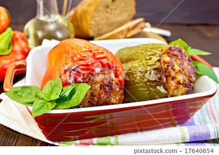 Pepper stuffed meat in brown roaster on table Pepper stuffed meat in brown roaster on table 17640654