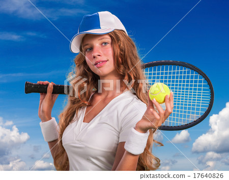 Girl  holding tennis  racket and ball on blue sky 17640826