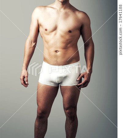young sexy man posing in white pants. 17641188