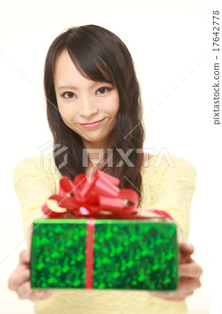A woman giving a gift A woman giving a gift 17642778