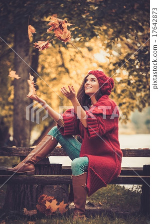 Woman wearing knitted coat in autumn park Woman wearing knitted coat in autumn park 17642873
