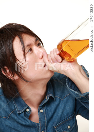 A man drinking a trumpet A man drinking a trumpet 17643829