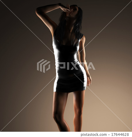 Sexy brunette woman posing in dark studio Sexy brunette woman posing in dark studio 17644628