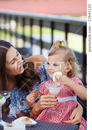 Happy mom and daughter eating ice cream Happy mom and daughter eating ice cream 17645120