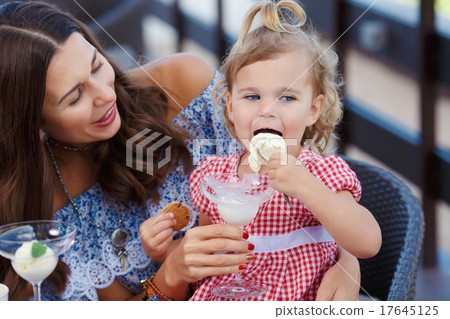 Happy mom and daughter eating ice cream Happy mom and daughter eating ice cream 17645125