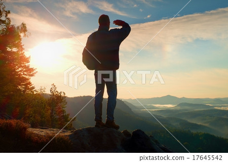 Silhouette of tourist with backpack. Suny daybreak 17645542