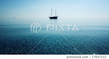 Morning sea with boat on the horizon. Aged photo. 17647222
