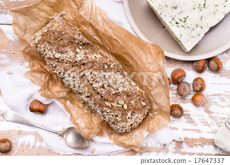 Bread with seeds cheese and huzelnuts on wood Bread with seeds cheese and huzelnuts on wood 17647337