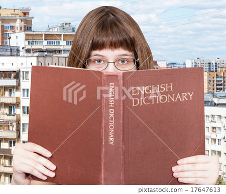 girl looks over English Dictionary and cityscape girl looks over English Dictionary and cityscape 17647613